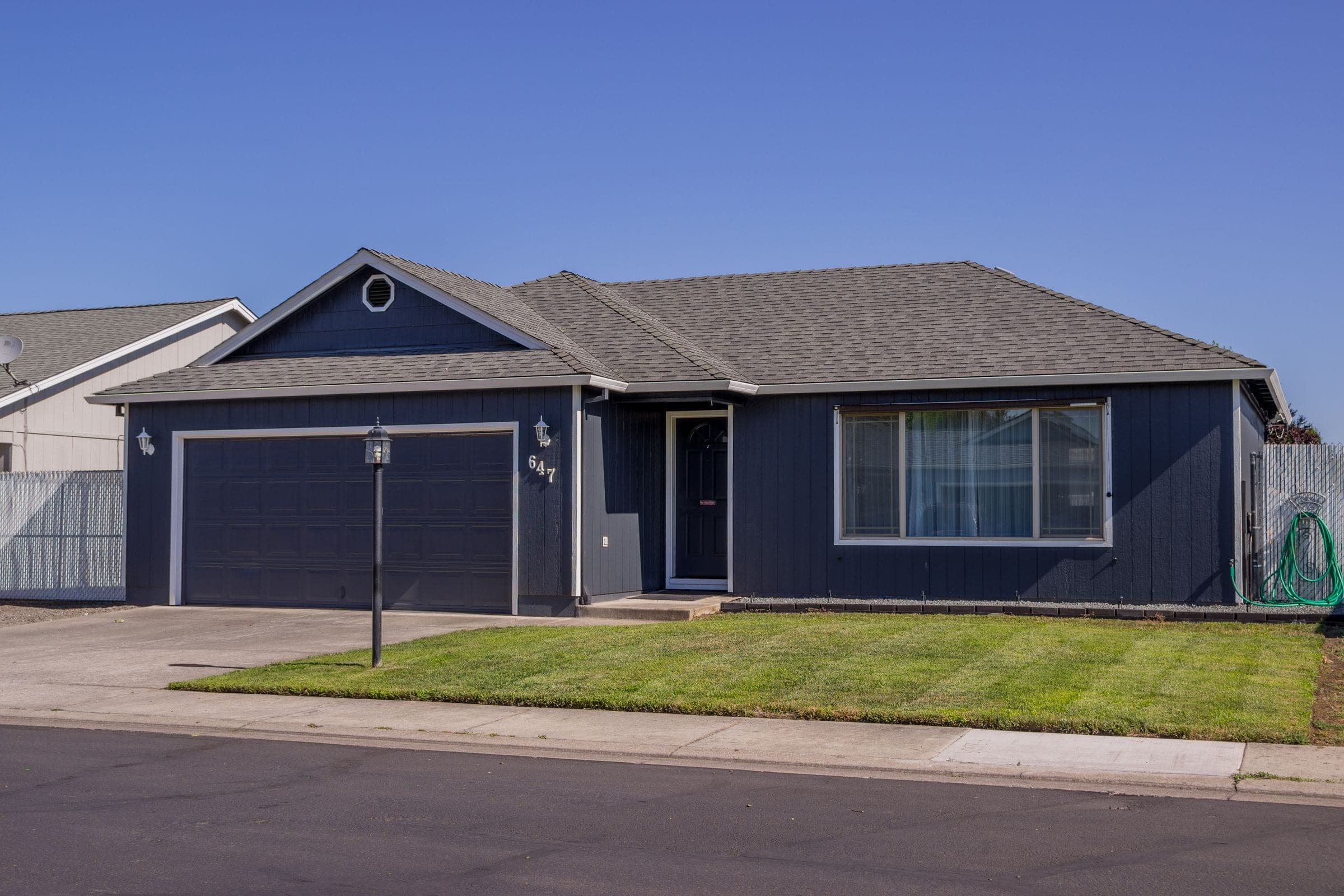 A newer ranch house with a two-car garage and a concrete driveway near Harrisburg, where we do mobile windshield replacement