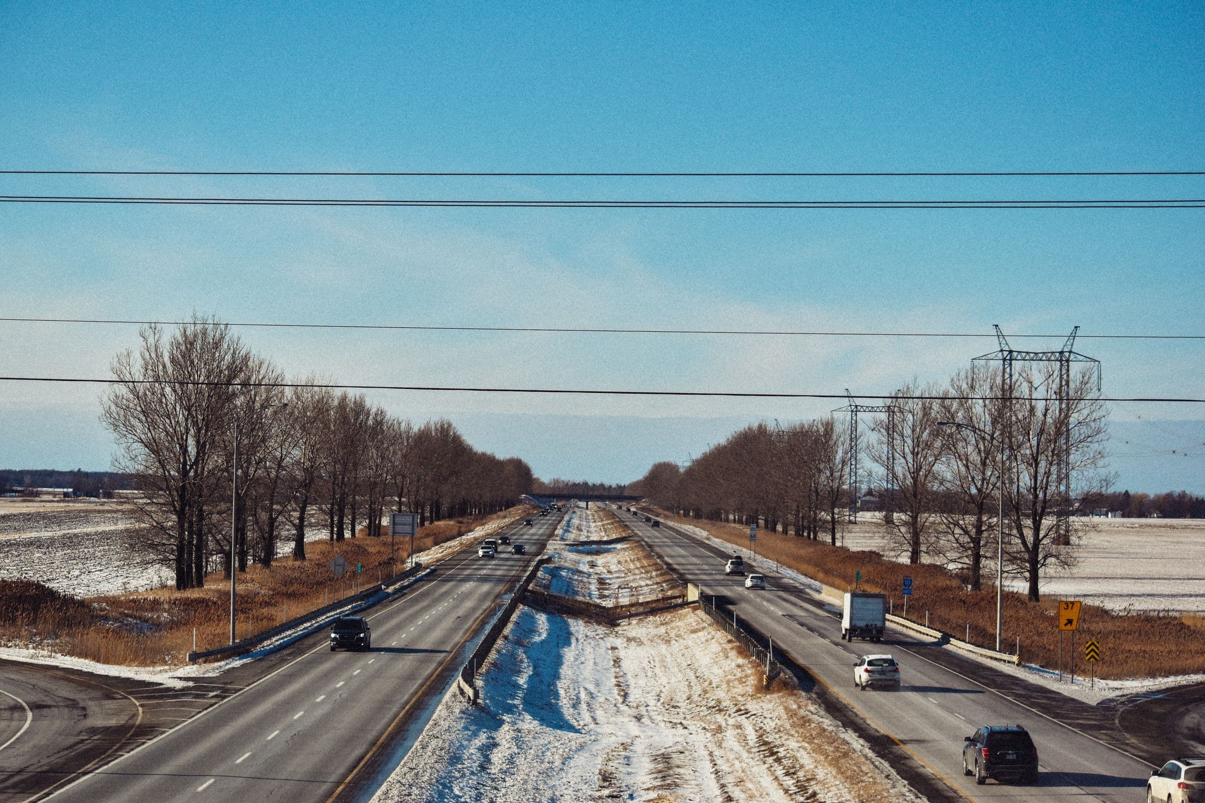 A divided interstate in winter with snow in the median near Lennox, where we do mobile windshield replacement