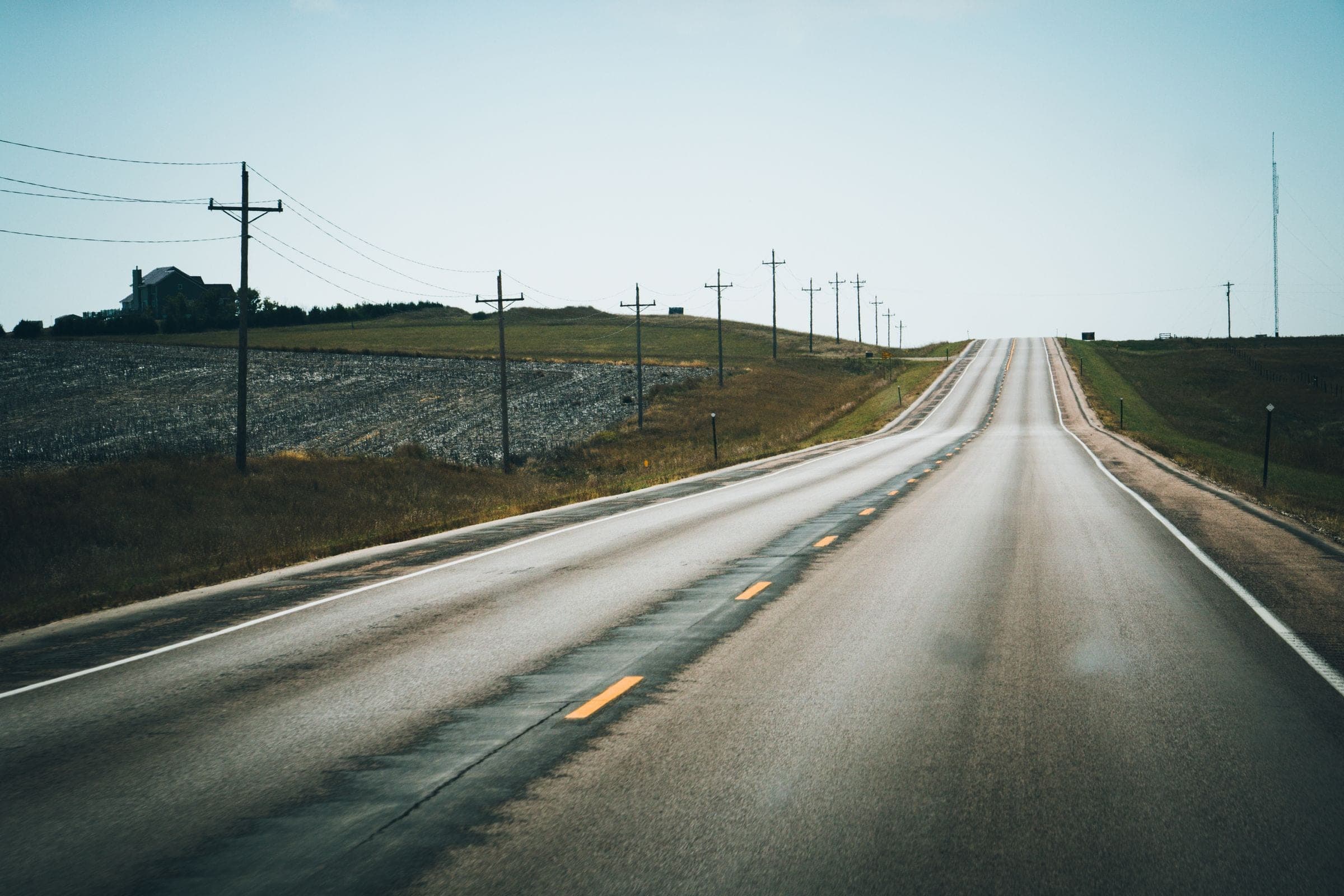 A two-lane state highway running past farmland and power lines near Renner, where we do mobile windshield replacement